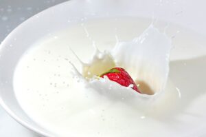 Colostrum supplement in a bowl with strawberry